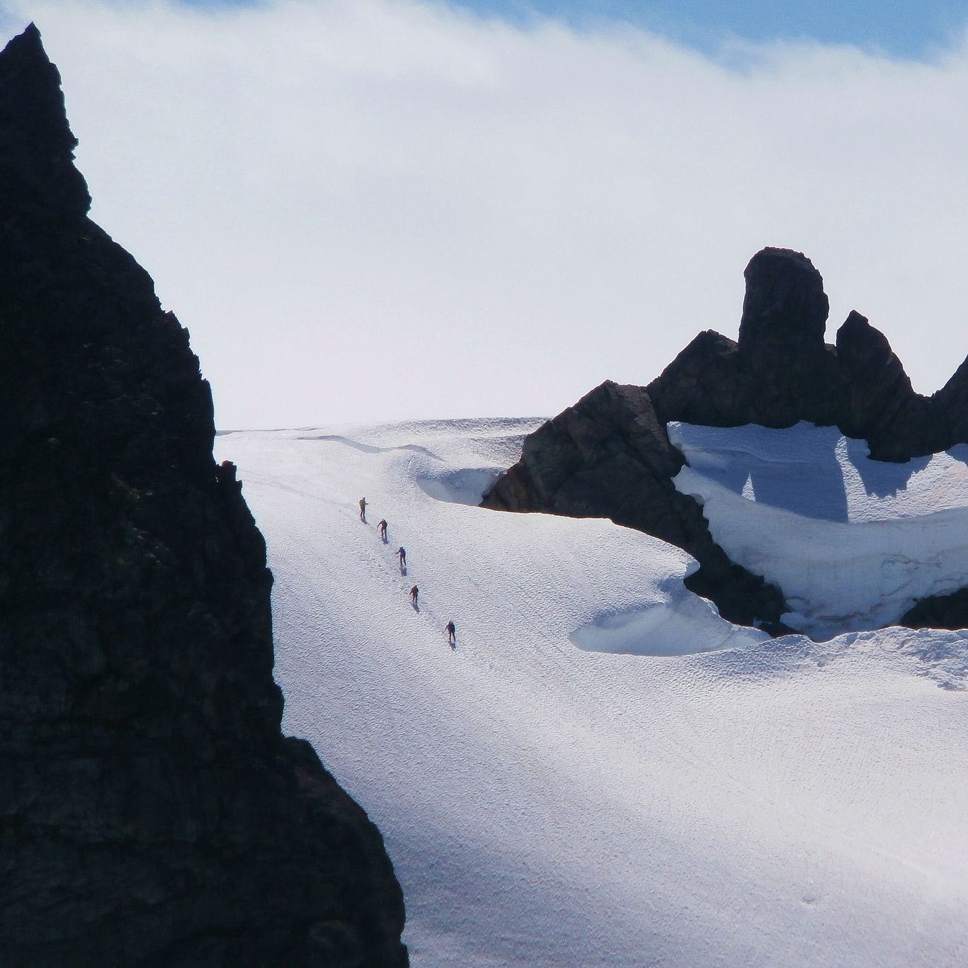 Climbers ascending a glacier